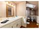 The bathroom has striped wallpaper, wood floors, wainscoting, and a white sink and toilet at 200 Rose St, Georgetown, CO 80444