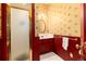 Bathroom features a shower, and a sink with custom red painted cabinetry at 200 Rose St, Georgetown, CO 80444