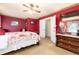 A bedroom features red walls, white trim and baseboards, and hardwood dresser at 200 Rose St, Georgetown, CO 80444