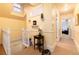 Hallway with yellow walls, carpeting, stairs, and table at 200 Rose St, Georgetown, CO 80444