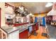 The chef's kitchen offers cherry cabinetry, granite counters, and hardwood floors and a view of the living room at 200 Rose St, Georgetown, CO 80444