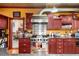 A chef's kitchen features a Viking range and hood, cherry cabinetry, granite counters, and an inviting open design at 200 Rose St, Georgetown, CO 80444