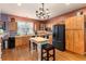 Eat-in kitchen with wooden cabinetry, modern appliances, hardwood floors, and pendant lighting at 200 Rose St, Georgetown, CO 80444
