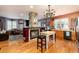 Cozy living room with stone fireplace, hardwood floors, eclectic decor, and kitchen view at 200 Rose St, Georgetown, CO 80444