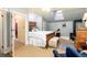 A bedroom features white bedding, a fireplace, and a blue armchair at 200 Rose St, Georgetown, CO 80444