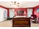 A spacious bedroom features red accent walls, carpeting, and a king bed at 200 Rose St, Georgetown, CO 80444