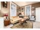 Cozy sitting room with plaid wallpaper, vintage furniture, and natural light at 200 Rose St, Georgetown, CO 80444