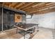 Finished basement area featuring ping pong table, chalkboard wall and exposed ceiling at 42363 Glen Abbey Dr, Elizabeth, CO 80107