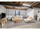 Spacious basement featuring a cozy seating area with a couch, table, and decor elements at 42363 Glen Abbey Dr, Elizabeth, CO 80107