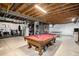 Versatile basement space with a pool table, exercise equipment, and ample room for various activities at 42363 Glen Abbey Dr, Elizabeth, CO 80107