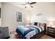 Comfortable bedroom with a cozy bed, a ceiling fan, and natural light from the window at 42363 Glen Abbey Dr, Elizabeth, CO 80107