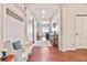 Inviting entryway with wood floors, a white bench, and decorative wall hooks provides style and practical storage at 42363 Glen Abbey Dr, Elizabeth, CO 80107