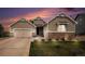Charming two-story home with neutral siding, stone accents, three-car garage, and manicured lawn at 42363 Glen Abbey Dr, Elizabeth, CO 80107