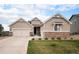 Charming single-Gathering home with a beige exterior, stone accents, and a well-maintained front yard at 42363 Glen Abbey Dr, Elizabeth, CO 80107