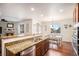 Open kitchen featuring granite countertops, stainless appliances, and adjacent dining area filled with natural light at 42363 Glen Abbey Dr, Elizabeth, CO 80107
