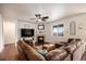 Inviting living room with a fireplace, large sectional sofa, and hardwood floors, perfect for relaxing and entertaining at 42363 Glen Abbey Dr, Elizabeth, CO 80107