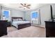Spacious main bedroom featuring a ceiling fan, plush carpet, and bright windows at 42363 Glen Abbey Dr, Elizabeth, CO 80107