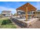 Backyard patio with pergola and stone surround, a relaxing spot for outdoor living at 42363 Glen Abbey Dr, Elizabeth, CO 80107