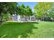 Expansive backyard featuring lush lawn, mature trees, and a patio area perfect for outdoor entertaining at 17395 E Dewberry Dr, Parker, CO 80134