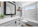 Stylish bathroom featuring modern vanity, decorative mirror, and tiled shower, blending functionality with elegance at 17395 E Dewberry Dr, Parker, CO 80134