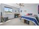 Bright bedroom featuring plush carpet, ceiling fan, and a window view for a cozy and inviting space at 17395 E Dewberry Dr, Parker, CO 80134