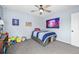 Cozy bedroom featuring plush carpet, ceiling fan, and ample lighting creating a warm and inviting atmosphere at 17395 E Dewberry Dr, Parker, CO 80134