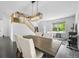 Open-concept dining area with dark wood floors, modern chandelier, and staircase at 17395 E Dewberry Dr, Parker, CO 80134