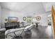 Open-concept dining room with dark wood floors, modern lighting, and stylish decor at 17395 E Dewberry Dr, Parker, CO 80134