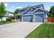 Charming two-story home featuring a covered front porch and a three car attached garage at 17395 E Dewberry Dr, Parker, CO 80134