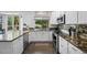 Bright kitchen featuring granite countertops, stainless appliances, and white cabinetry at 17395 E Dewberry Dr, Parker, CO 80134