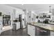 Open kitchen with stainless steel appliances and granite countertops, leading to the living area at 17395 E Dewberry Dr, Parker, CO 80134