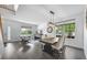 Bright living room features dark wood floors, large windows, and a dining area at 17395 E Dewberry Dr, Parker, CO 80134