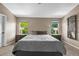 Comfortable main bedroom with dual nightstands, lamps, and large windows offering natural light at 17395 E Dewberry Dr, Parker, CO 80134