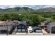 Aerial view showcases the home's spacious backyard, garage, and proximity to lush green spaces and mountains at 2221 Illinois St, Golden, CO 80401