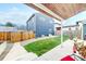 Well-maintained backyard featuring manicured lawn, stone garden area, and patio at 2221 Illinois St, Golden, CO 80401