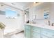 Bright bathroom with vanity, shower-tub combo, and decorative tile accent at 2221 Illinois St, Golden, CO 80401