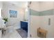 Stylish bathroom boasts modern finishes, glass shower, and elegant blue vanity at 2221 Illinois St, Golden, CO 80401