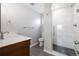 Modern bathroom featuring glass-enclosed shower with tiled walls, stylish vanity, and wood-look floor tiles at 2221 Illinois St, Golden, CO 80401