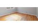 Bright bedroom features hardwood floors, baseboard trim, neutral walls, and a window for natural light at 2221 Illinois St, Golden, CO 80401
