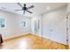 Bright, minimalist bedroom with hardwood floors, a ceiling fan, and ample natural light at 2221 Illinois St, Golden, CO 80401