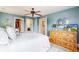 Spacious bedroom with white linens, natural light, and ensuite bath and closet at 2221 Illinois St, Golden, CO 80401