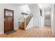 Welcoming entryway featuring hardwood floors, a staircase, and a beautiful front door at 2221 Illinois St, Golden, CO 80401