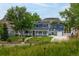 Charming two-story home with a welcoming front porch and well-maintained lawn, set against a scenic mountain backdrop at 2221 Illinois St, Golden, CO 80401