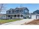 Two-story home featuring blue siding, white trim, a covered front porch, and a driveway at 2221 Illinois St, Golden, CO 80401