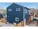 The back of the house features a deck, wood fence, metal planters, and access via stairs at 2221 Illinois St, Golden, CO 80401