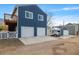 The back of the house features a deck, a white fence, and a two-car garage at 2221 Illinois St, Golden, CO 80401