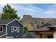 Exterior view of the home featuring dark blue siding with the mountains in the background at 2221 Illinois St, Golden, CO 80401