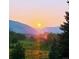 Beautiful scenic view of sunset over golf course with mountain in background at 2221 Illinois St, Golden, CO 80401