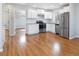 Bright kitchen features white cabinets, stainless steel appliances and hardware floors at 2221 Illinois St, Golden, CO 80401