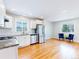 Bright open kitchen with stainless steel appliances, granite counters, subway tile backsplash, and wood floors at 2221 Illinois St, Golden, CO 80401